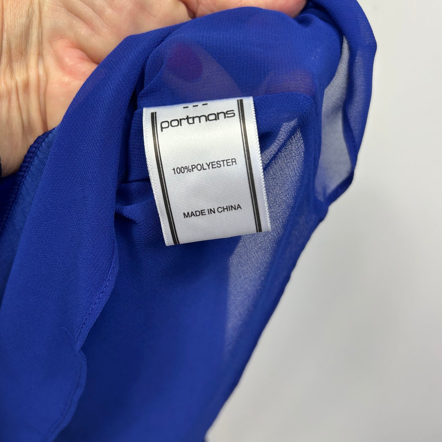 Blue polyester garment label detail view