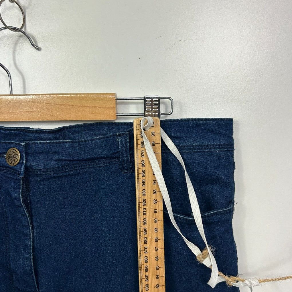 Dark blue denim jeans with measuring tape detail view