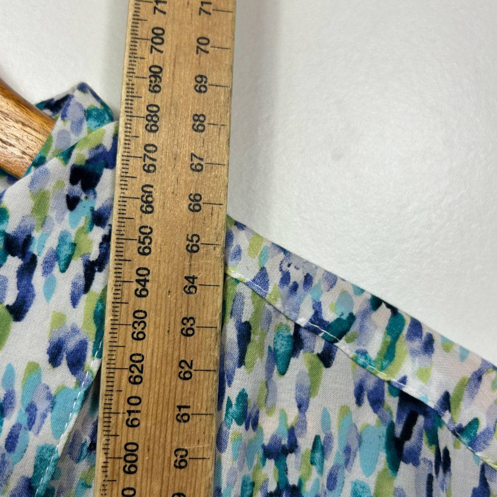 Blue green and white patterned fabric detail view with measuring ruler