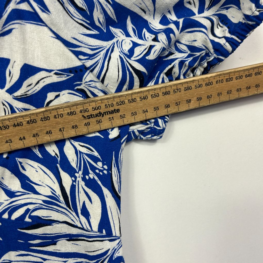 Blue and white floral fabric with measuring tape detail view