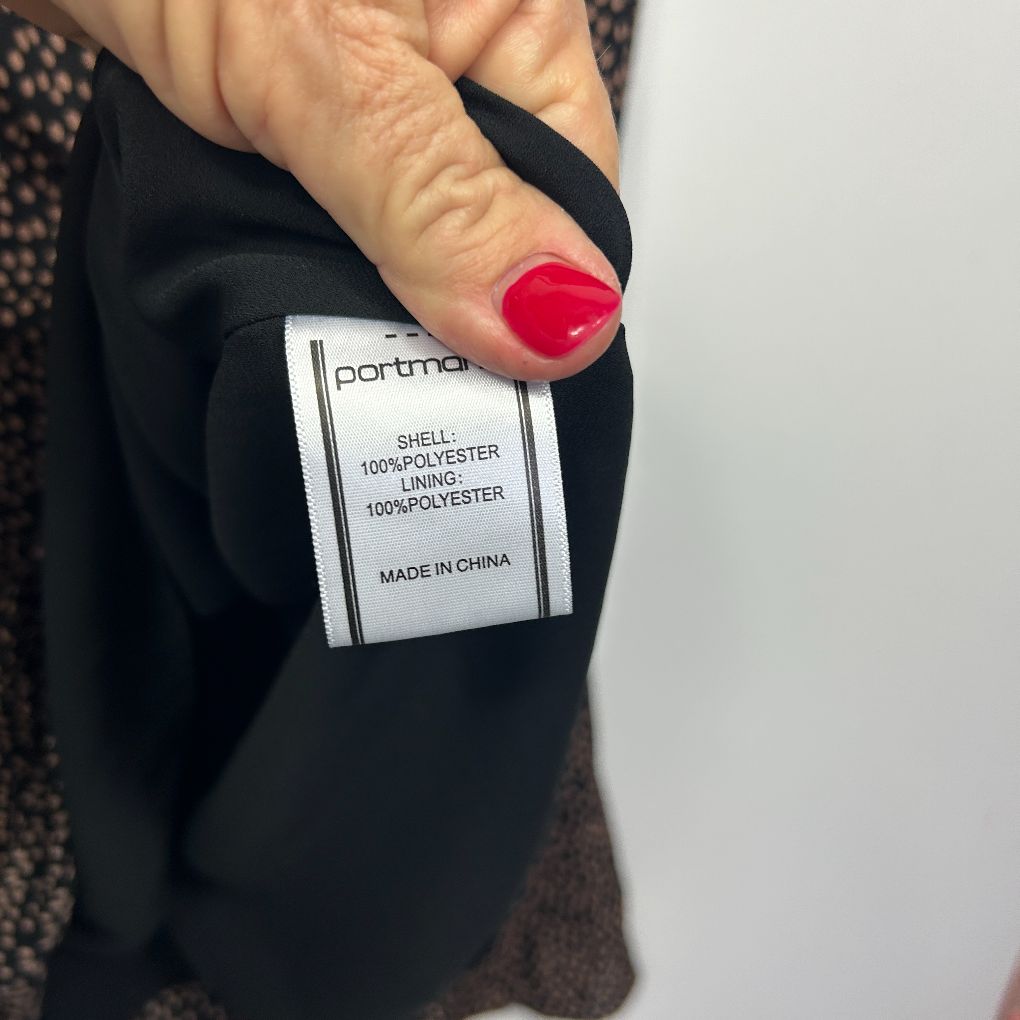 Black garment label detail view showing Portmans brand tag