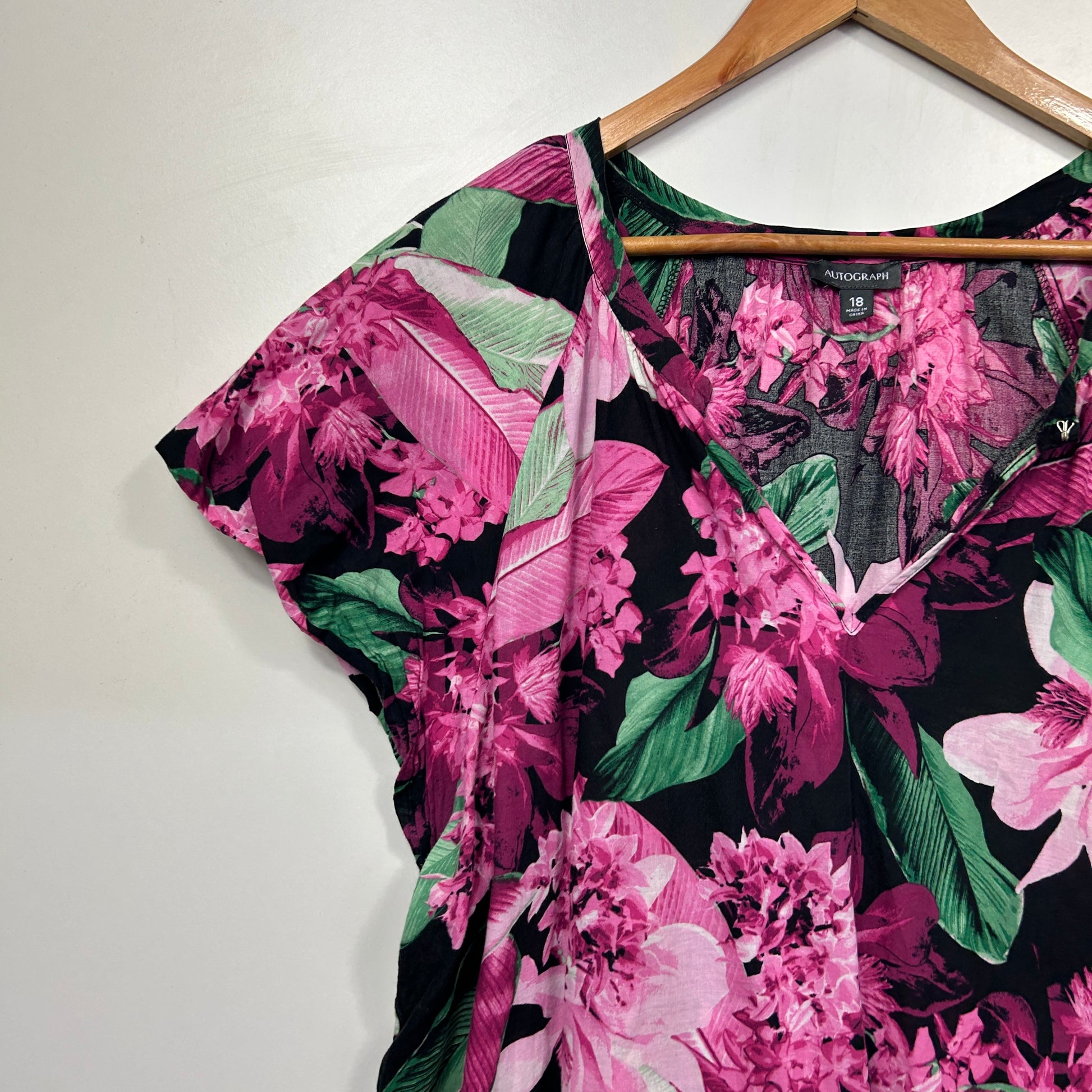 Pink floral top front view on hanger