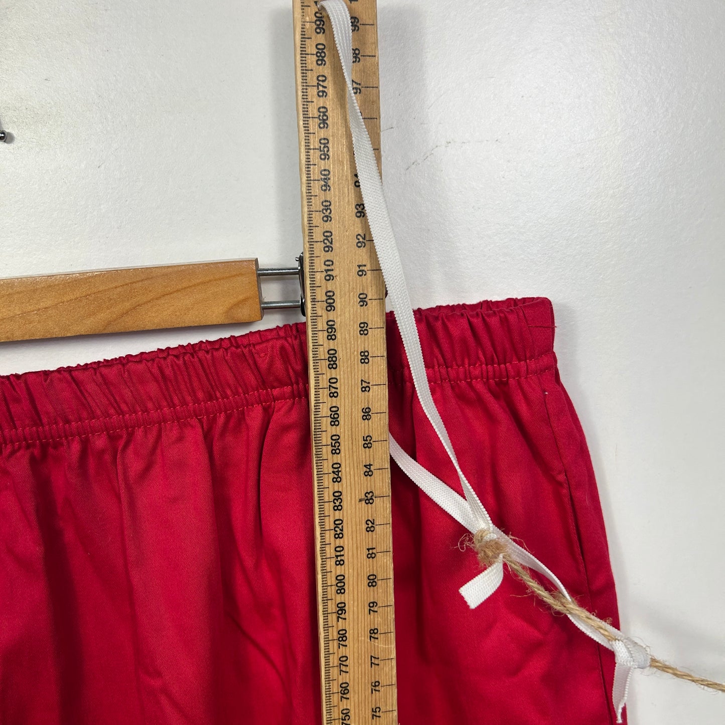 Red shorts detail view with measuring tape