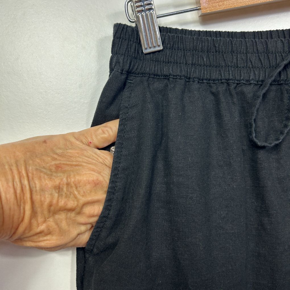 Black pants front view with pocket detail