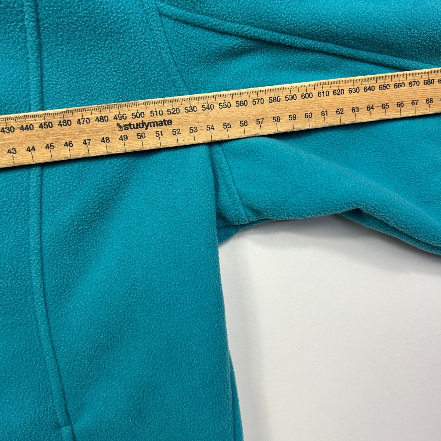Teal fabric with measuring tape detail view