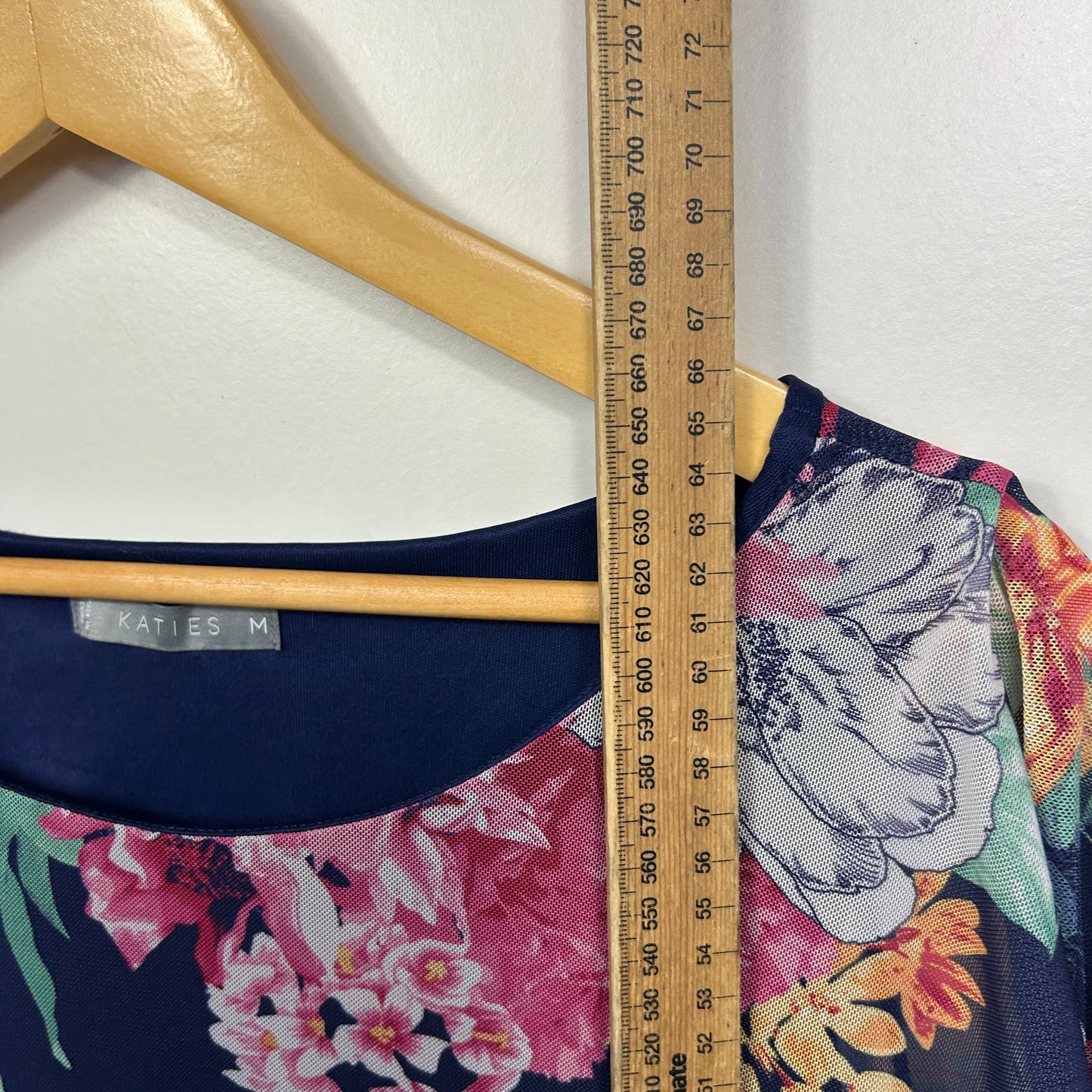 Navy floral top with size M label detail view