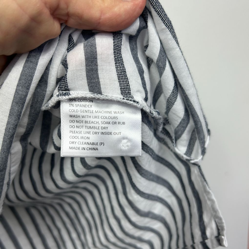 Grey and white striped garment label detail view