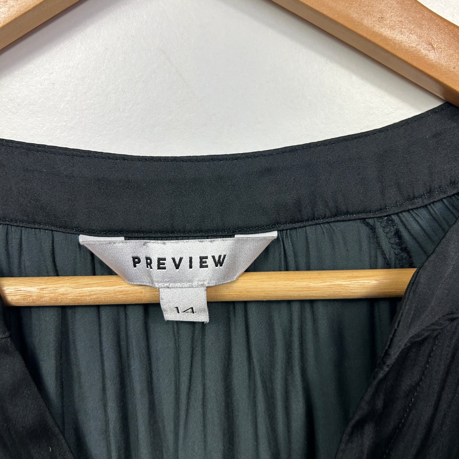 Black blouse front view on hanger