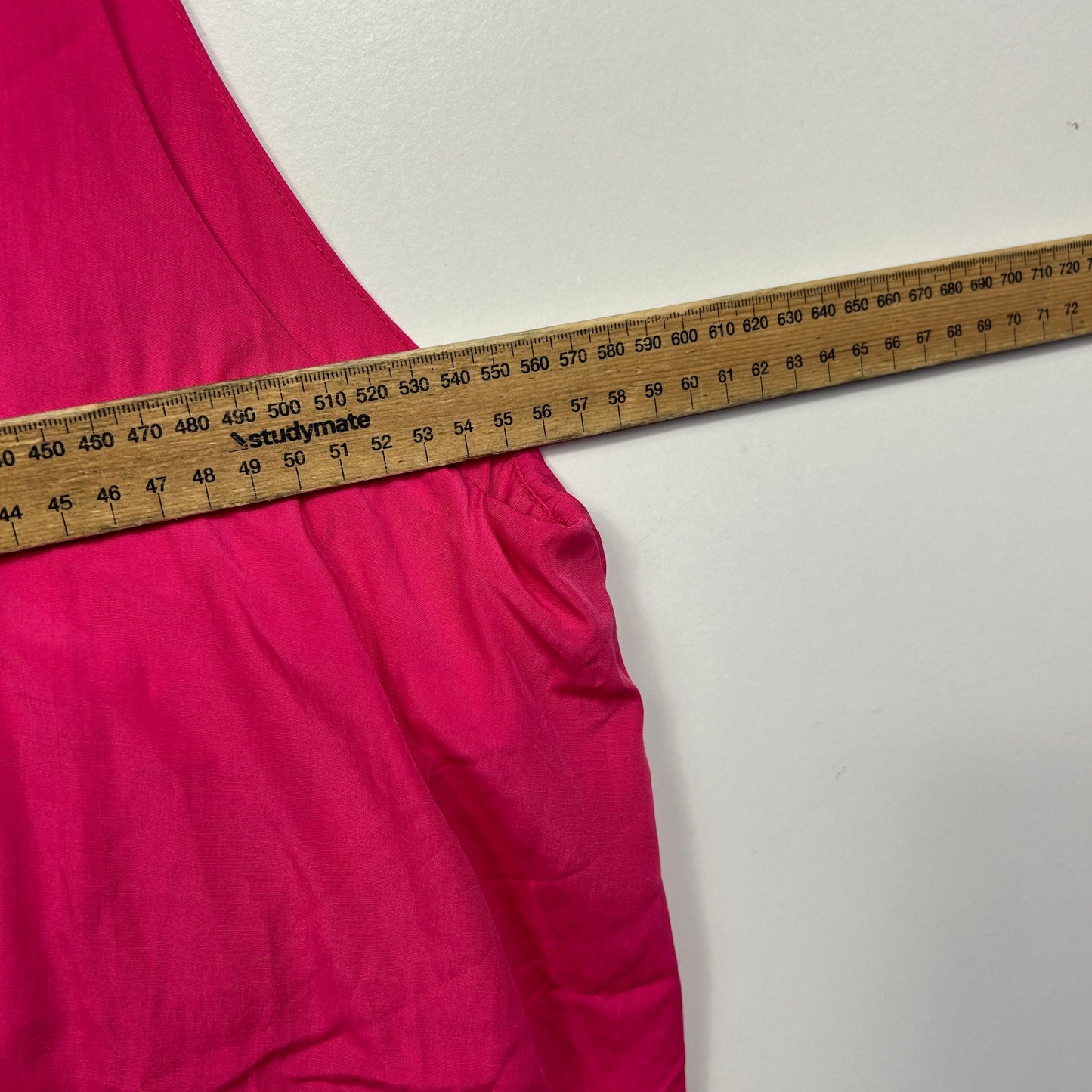 Pink fabric with measuring tape detail view