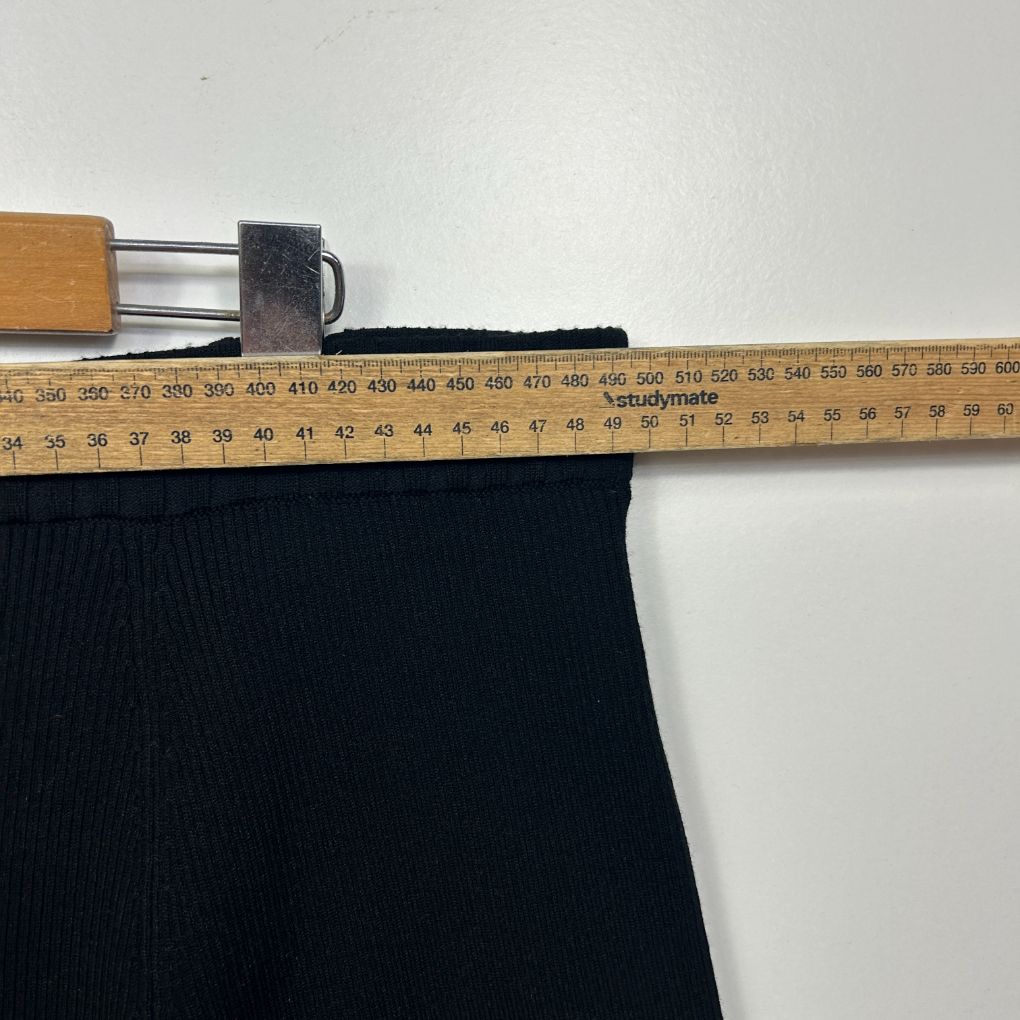 Black ribbed fabric detail view with ruler measurement