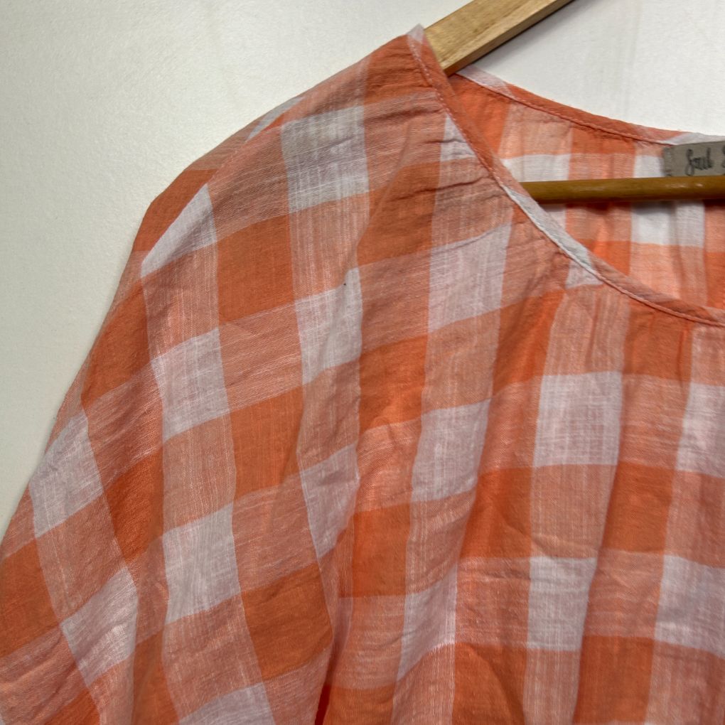 Orange and white checked shirt detail view
