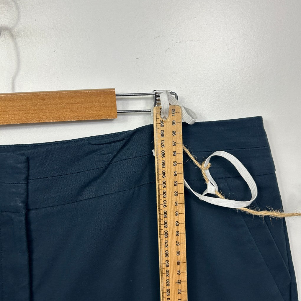 Navy pants waistband detail view with measuring tape