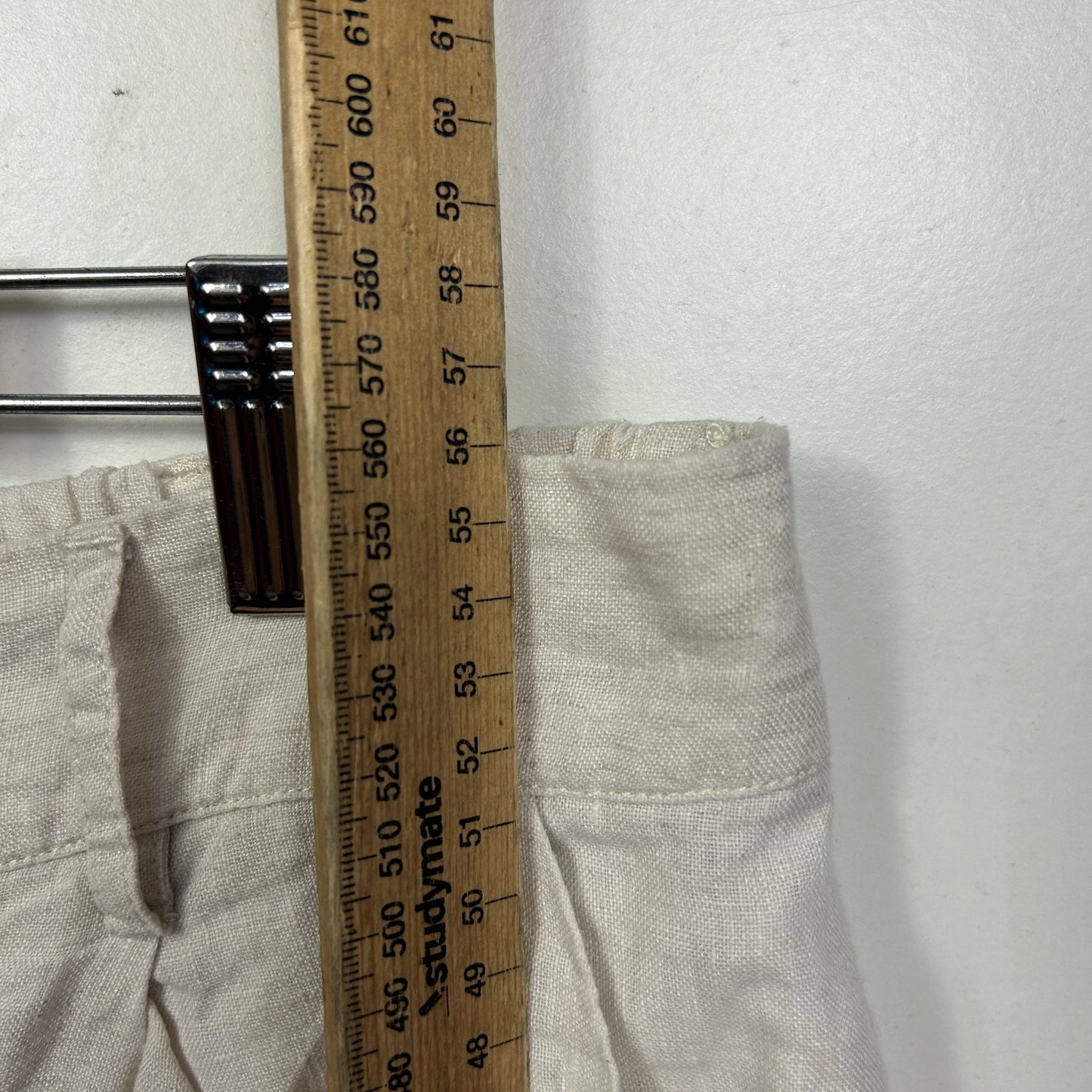 White linen trousers detail view with measuring tape