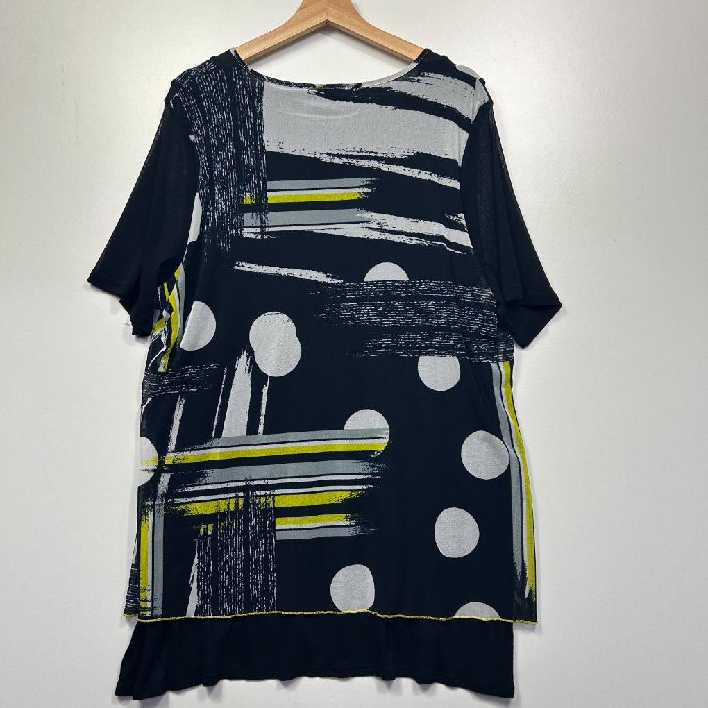 Navy tunic top front view with white polka dots and yellow striped graphic design