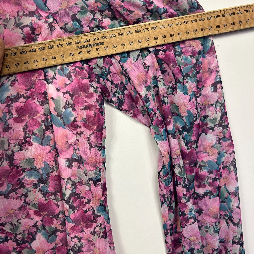 Pink floral pants detail view with measuring tape