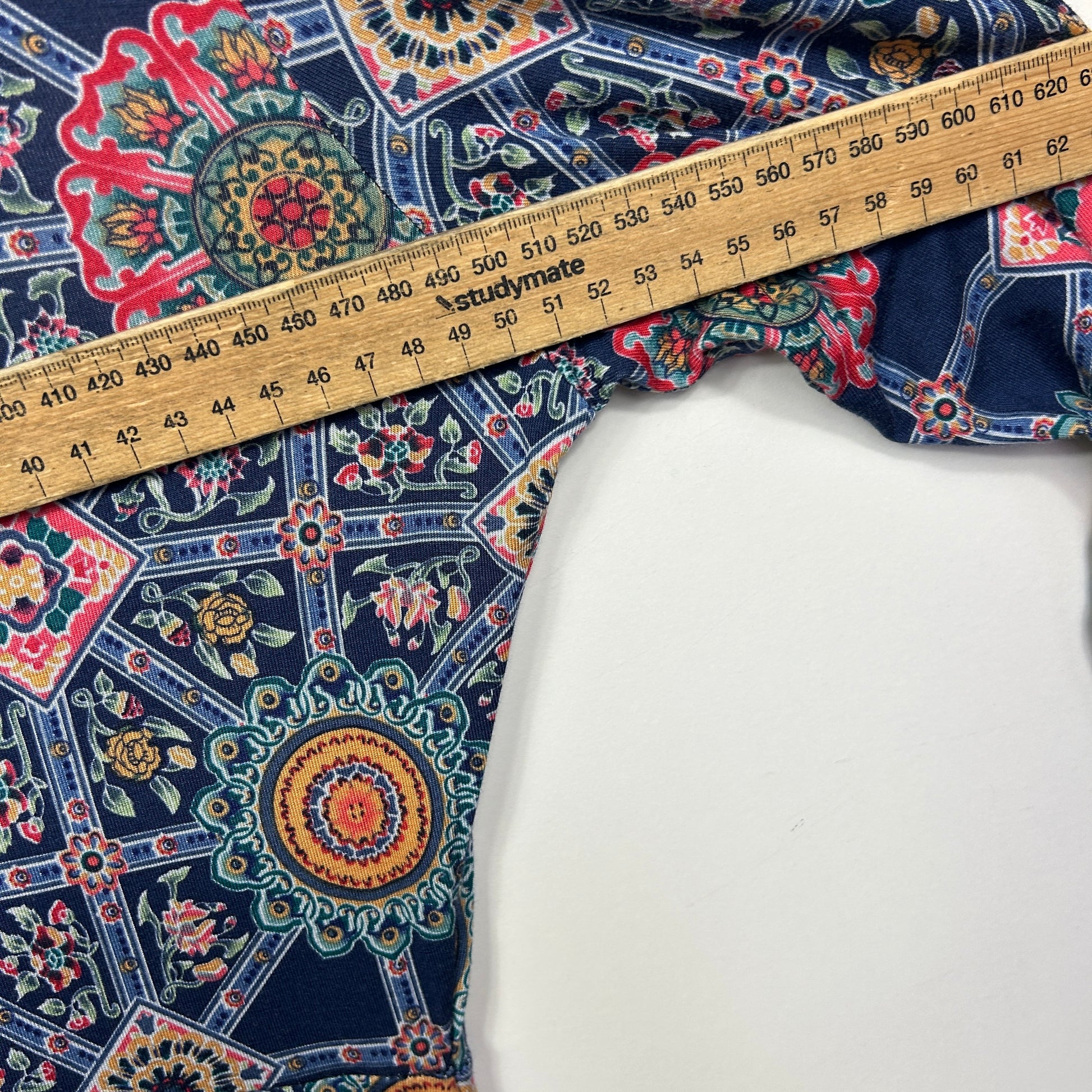 Navy floral patterned fabric detail view with measuring tape