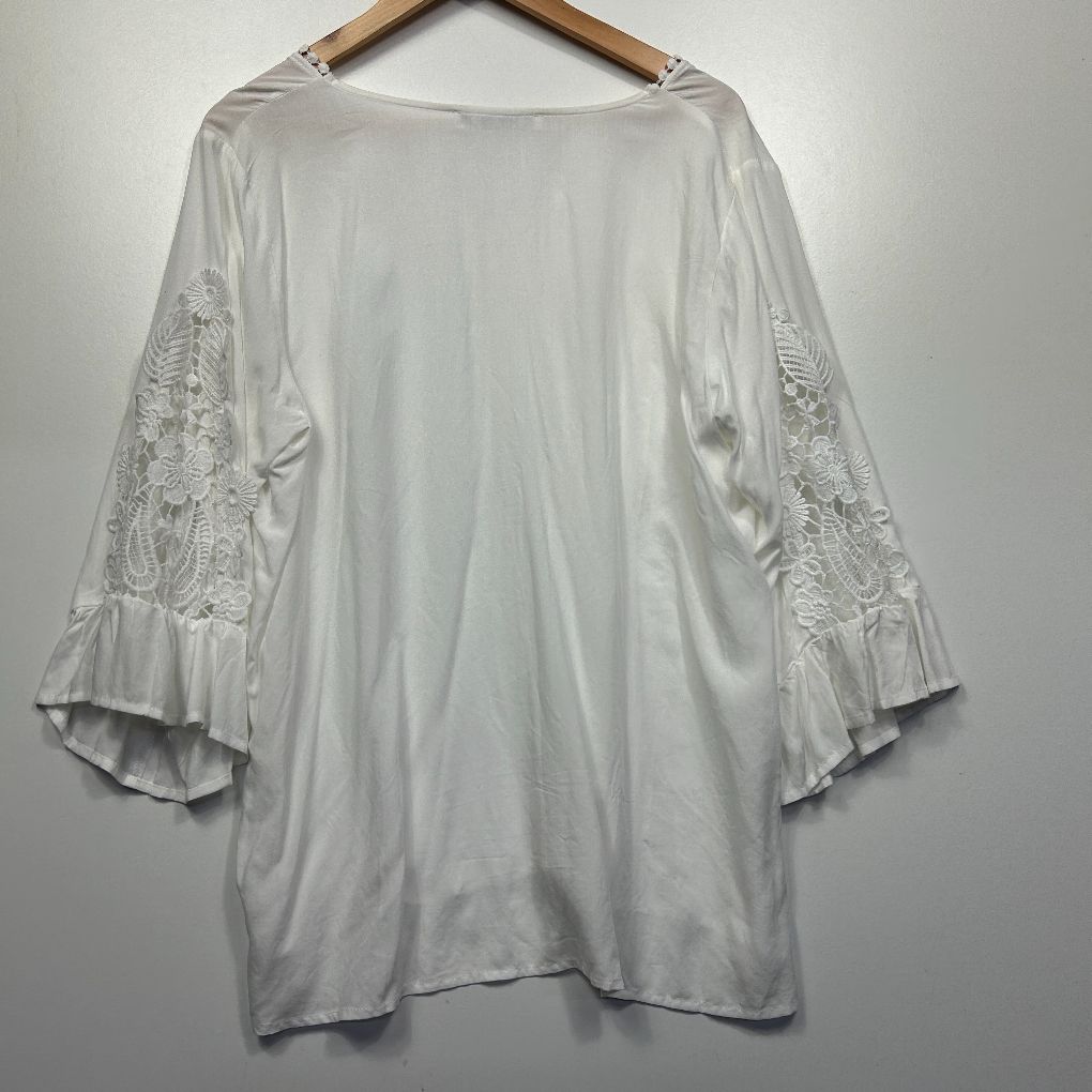 White tunic top front view with lace bell sleeves