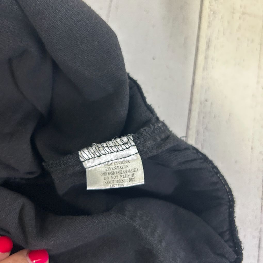 Black pants detail view showing waistband and label