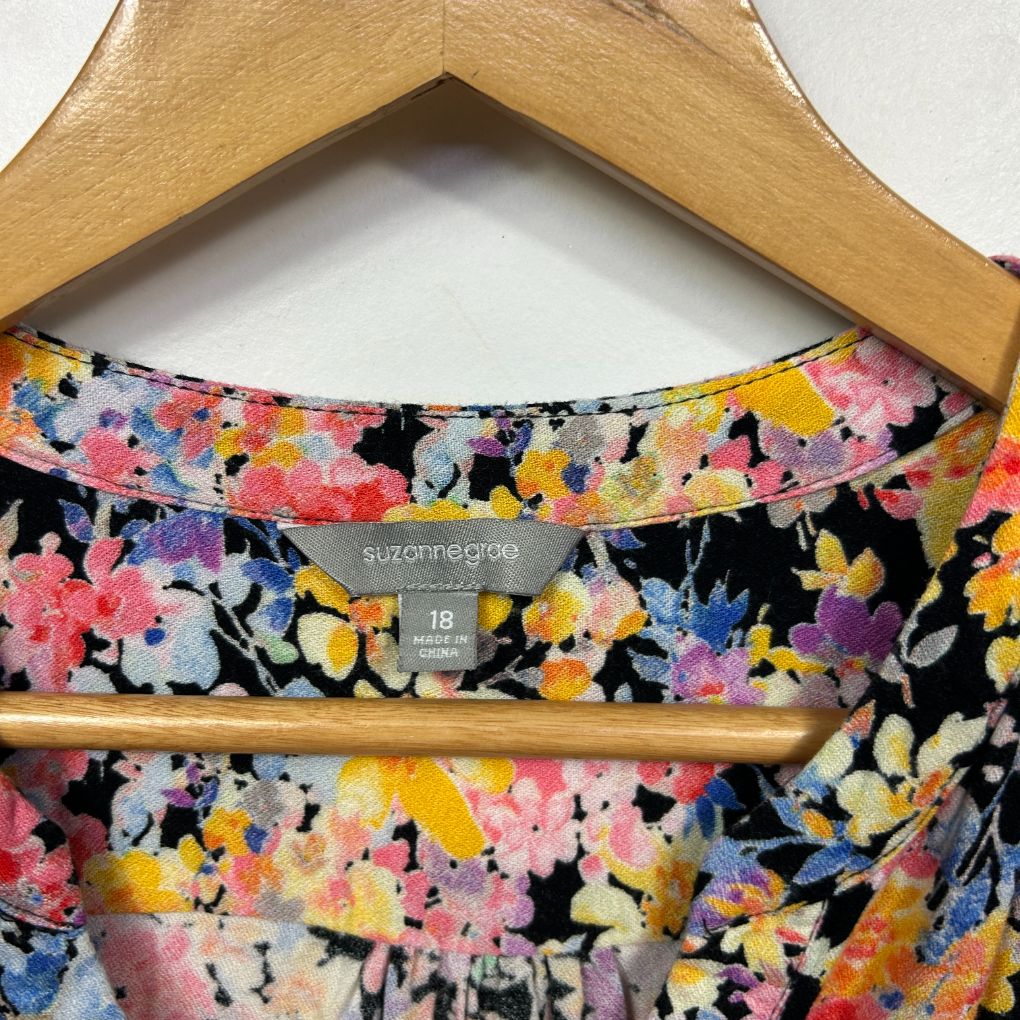 Floral print dress on wooden hanger detail view