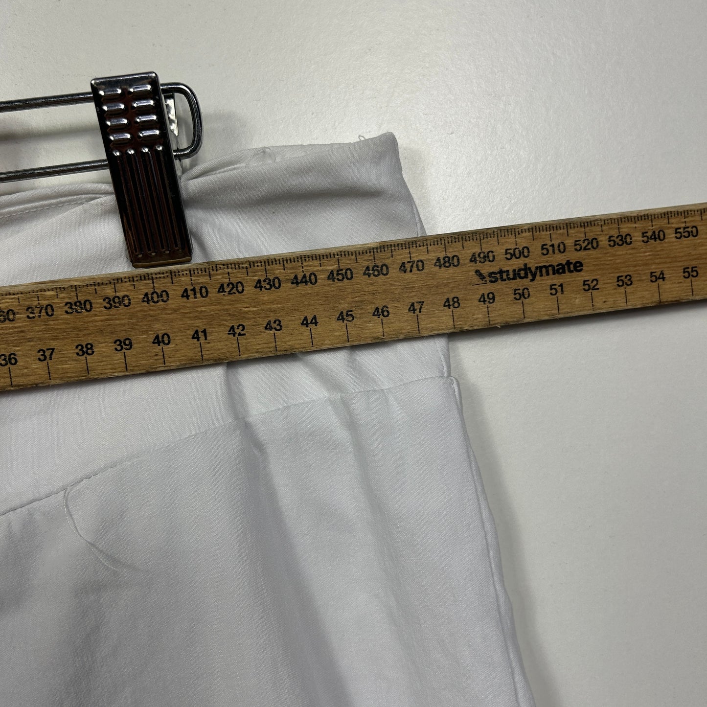 White shirt front view with measuring tape