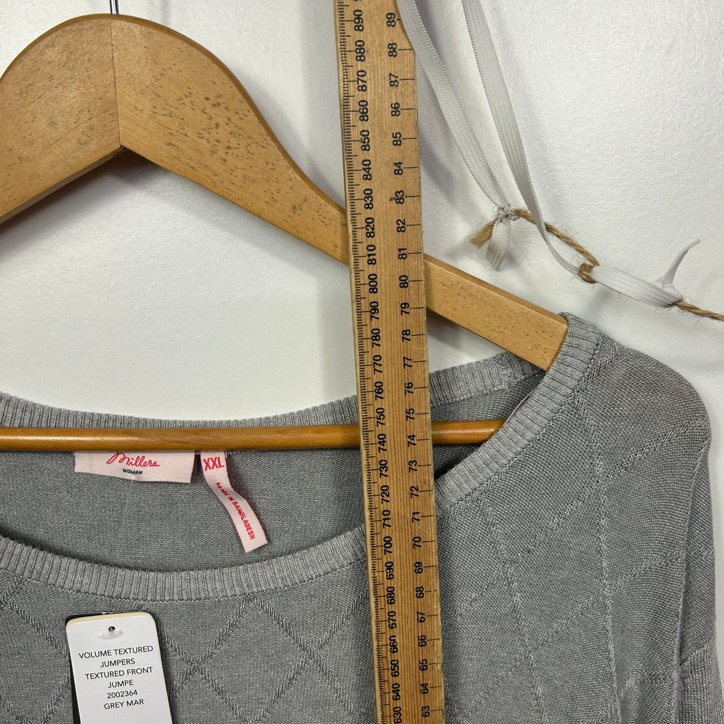 Grey long sleeve top front view with measuring tape