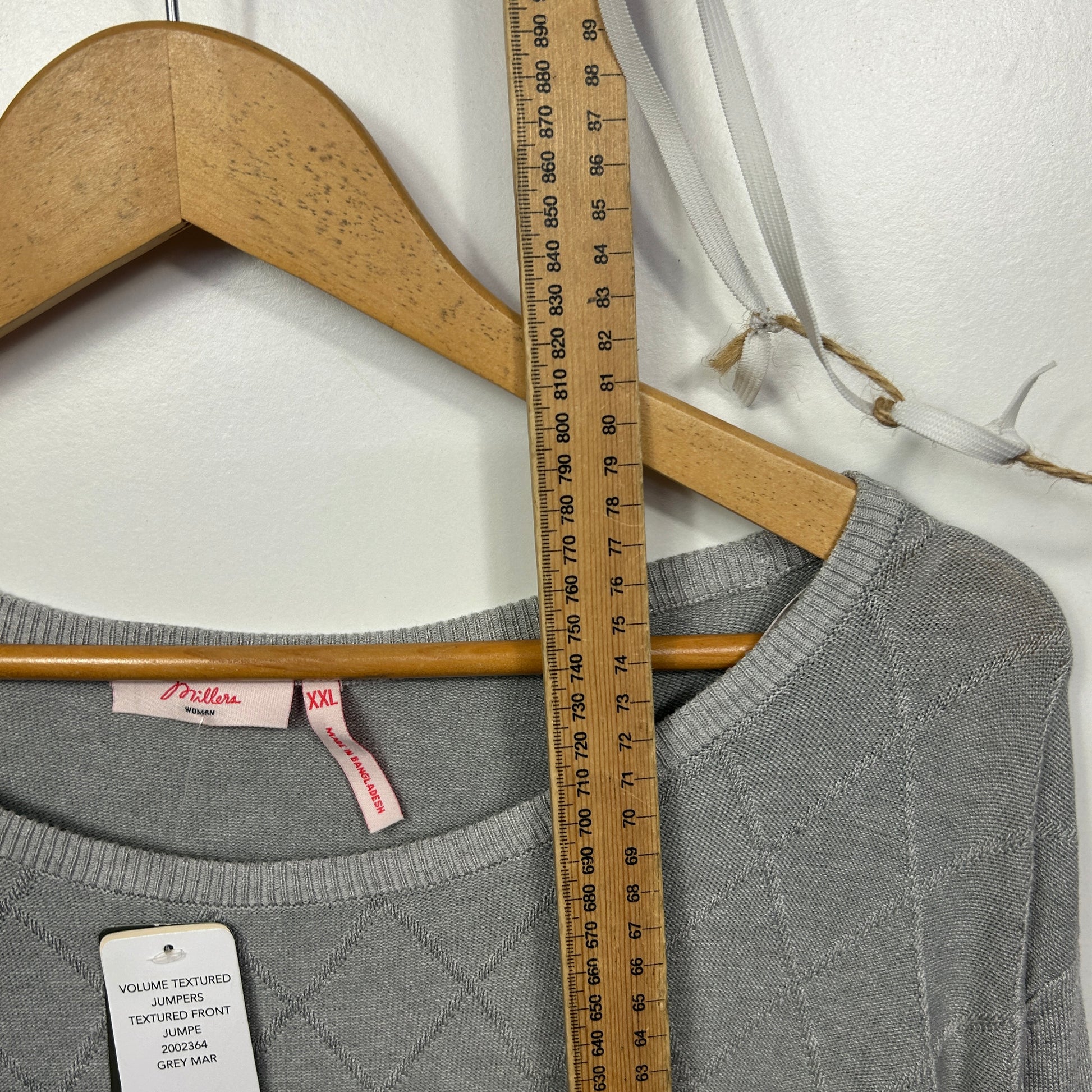 Grey long sleeve top front view with measuring tape