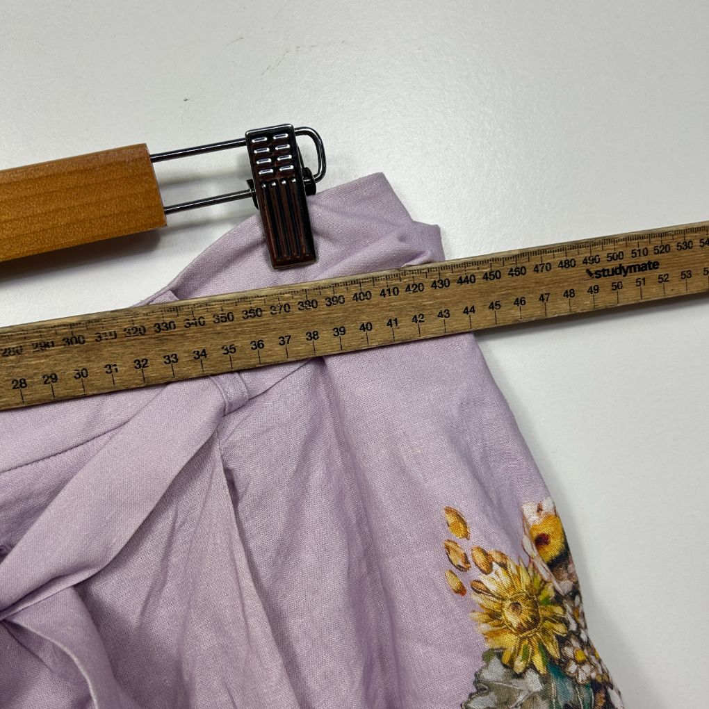 Lavender top front view with yellow floral design being measured