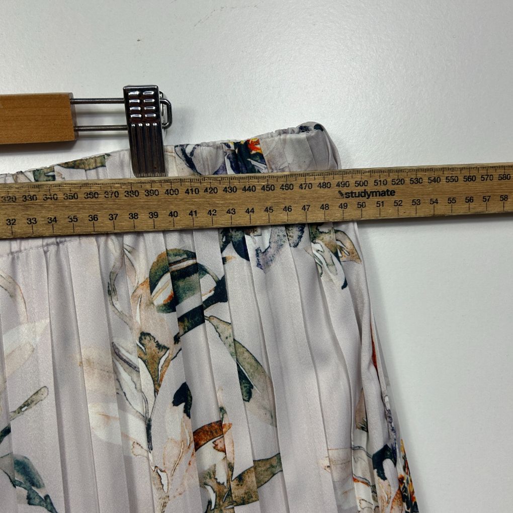 White floral skirt detail view on measuring tape