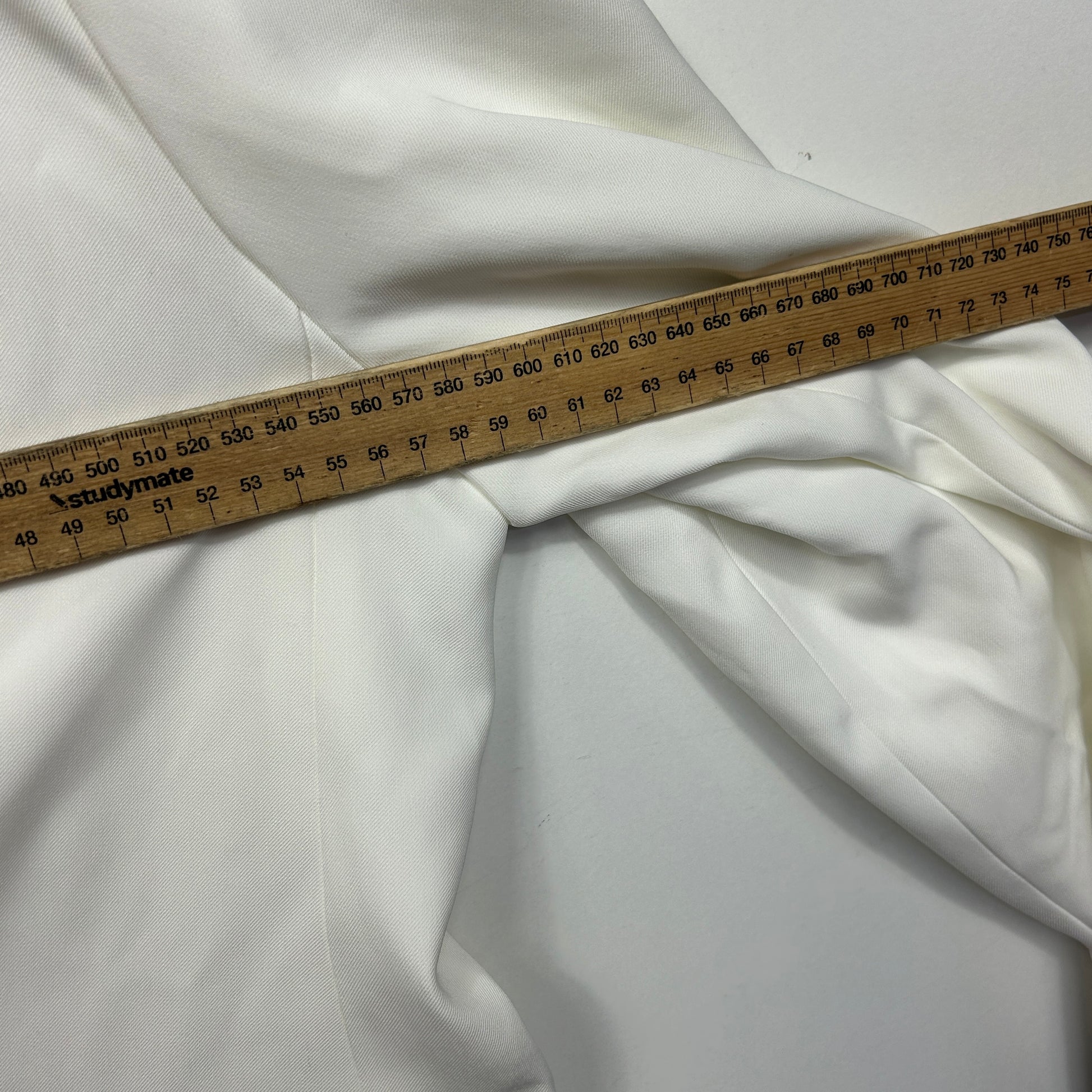 White fabric detail view with measuring tape