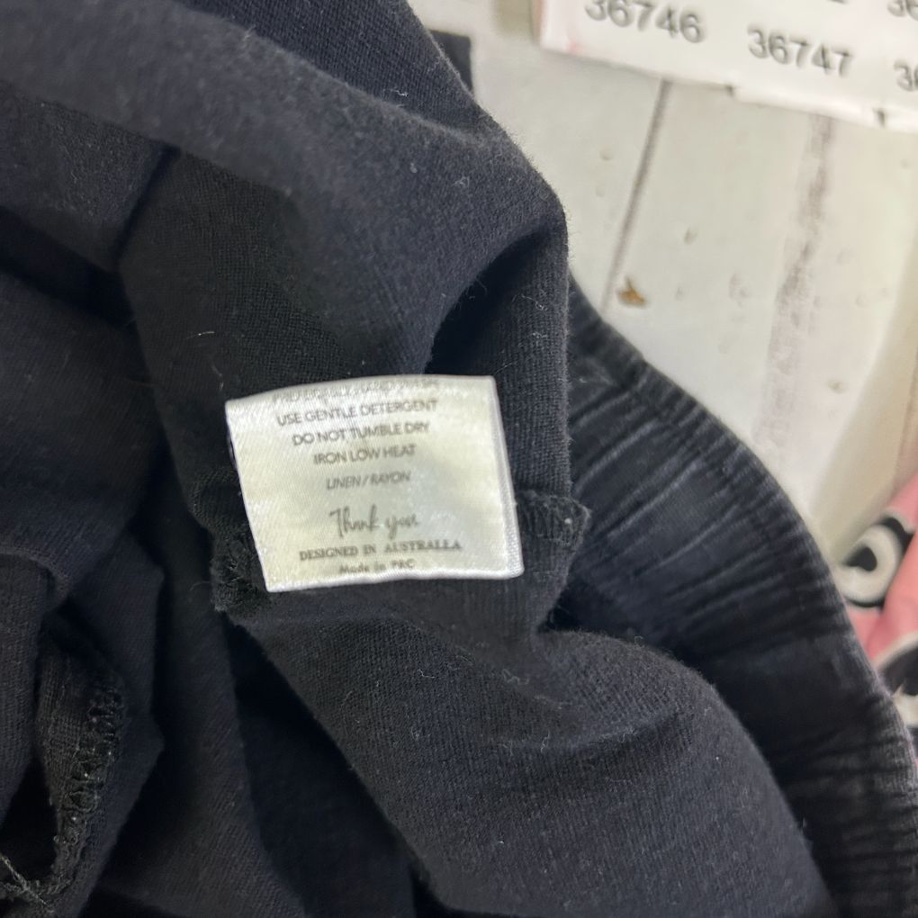 Black sweater detail view showing care label