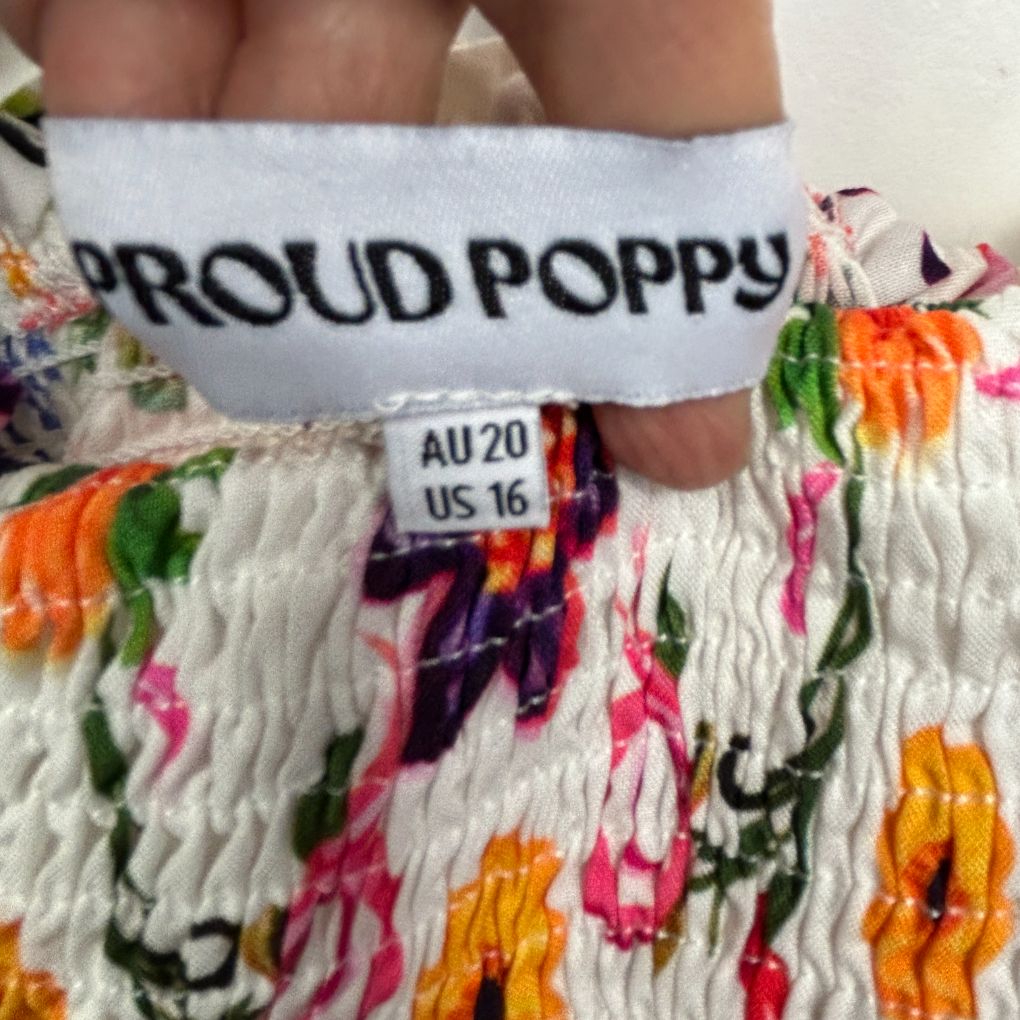White crop top with Proud Poppy text front detail view