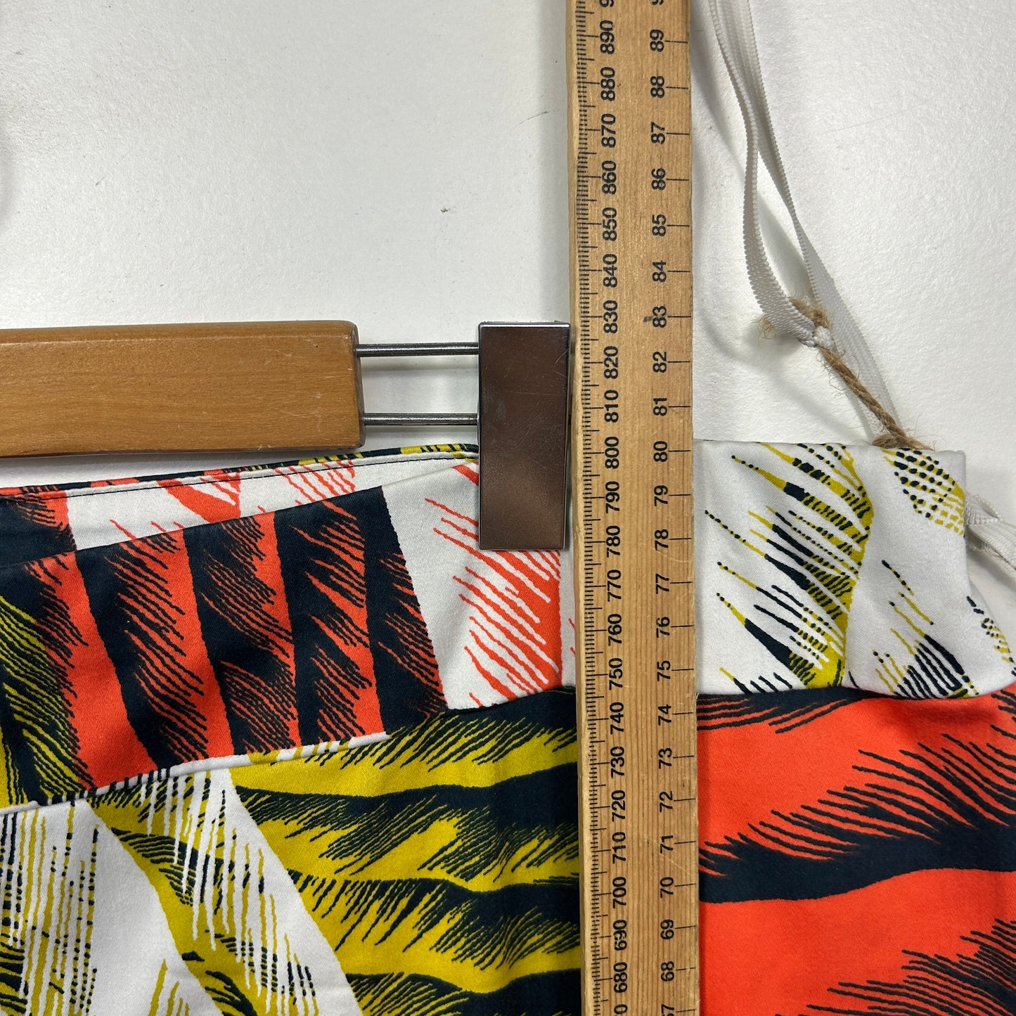 Colorful patterned fabric detail view with measuring tape