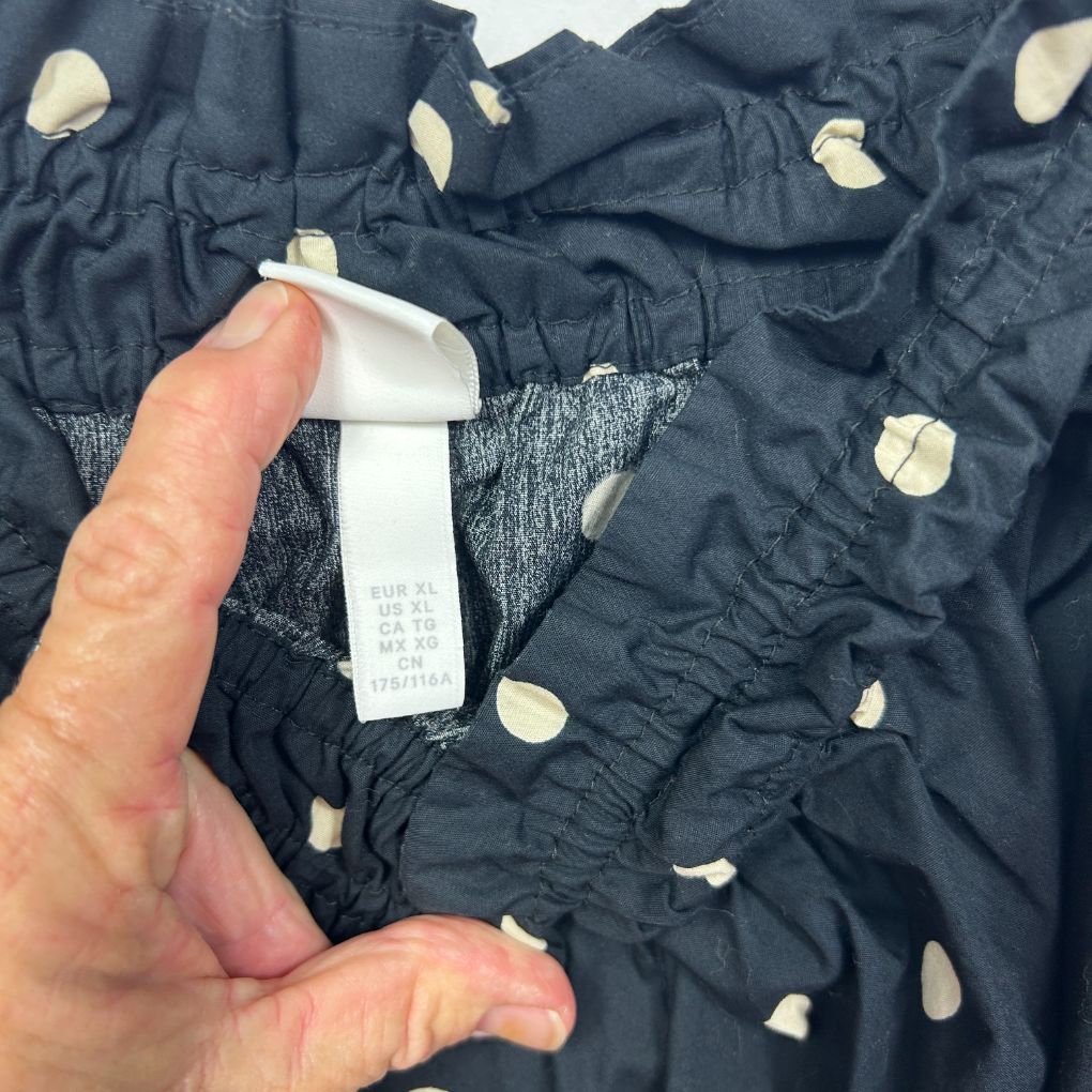 Navy jacket with polka dot pattern detail view