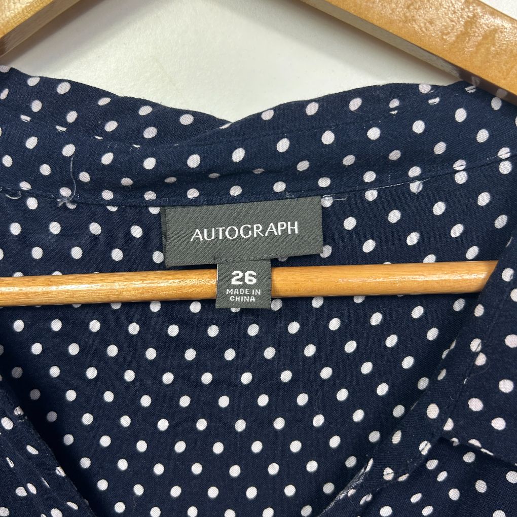 Navy polka dot shirt label detail view