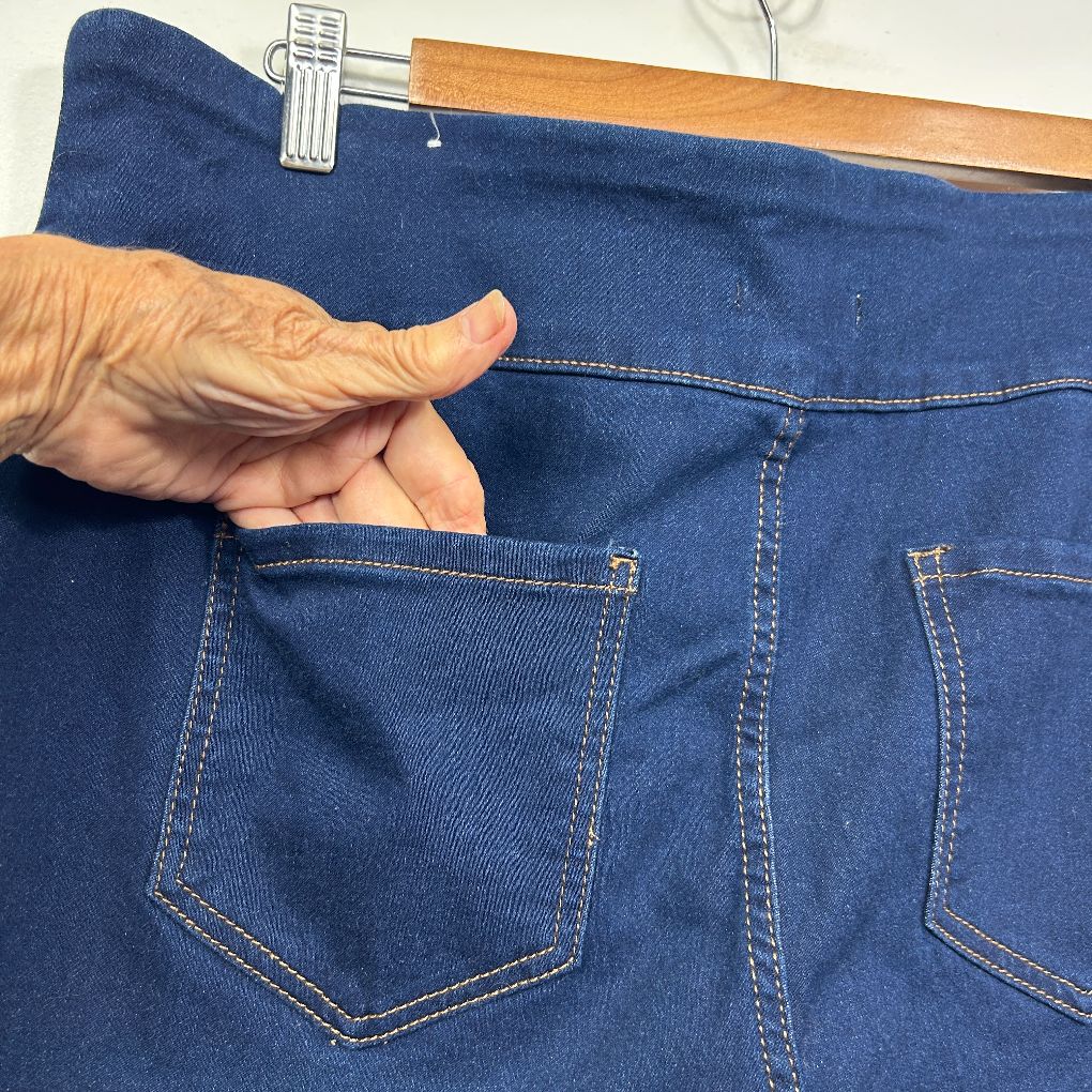 Blue denim jeans back pocket detail view