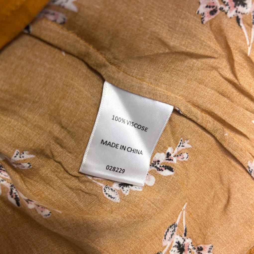 Tan viscose top with floral embroidery detail and fabric label