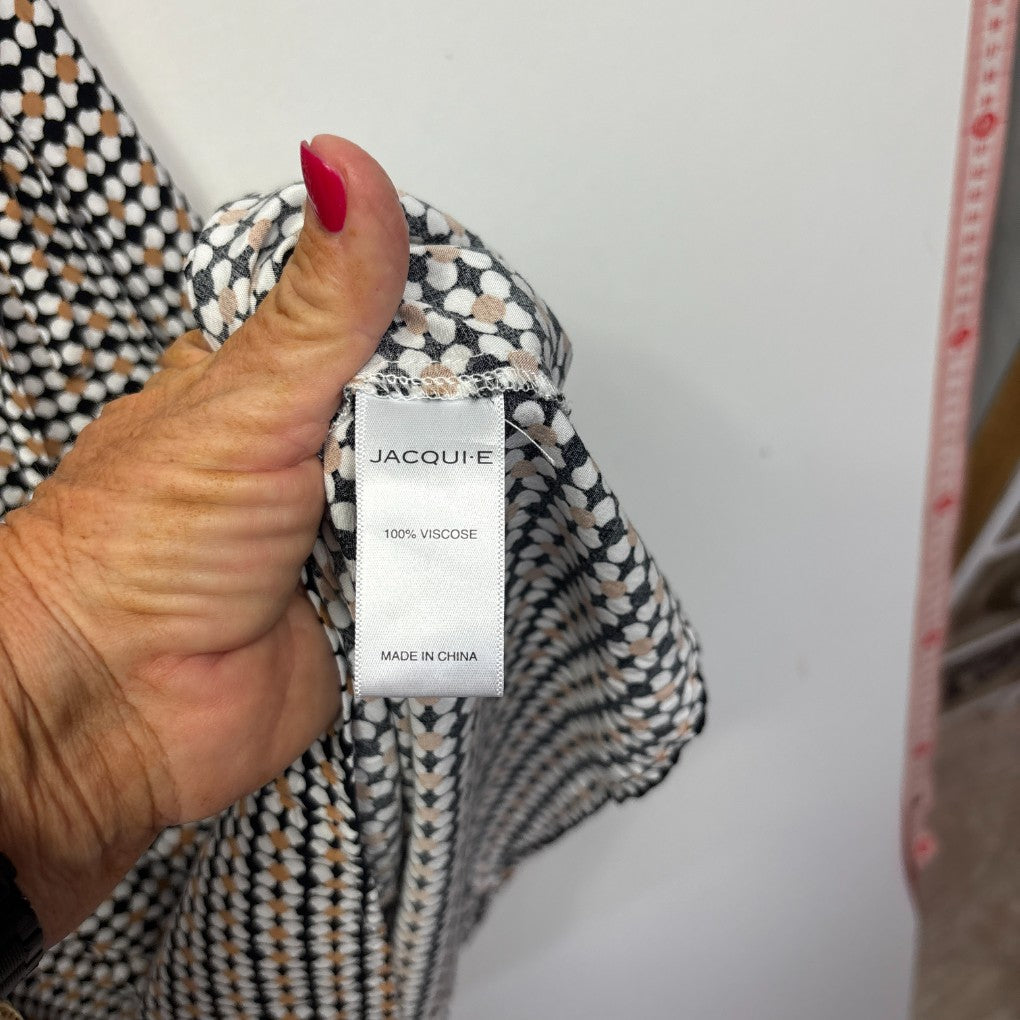 Black and white houndstooth jacket detail view showing Jacquie label