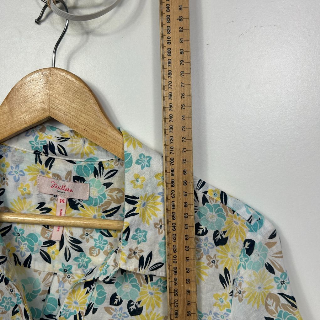 Floral shirt front view on wooden hanger with measuring tape