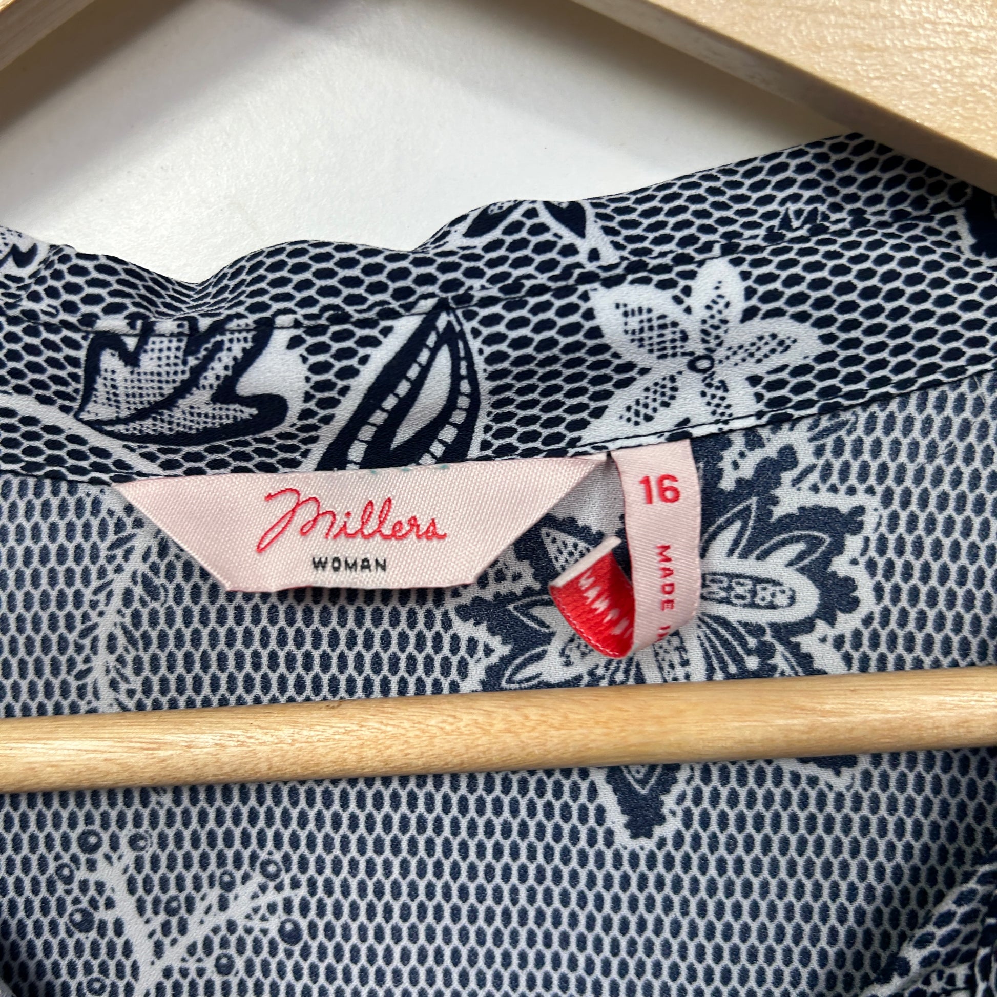 Navy and white floral blouse label detail view