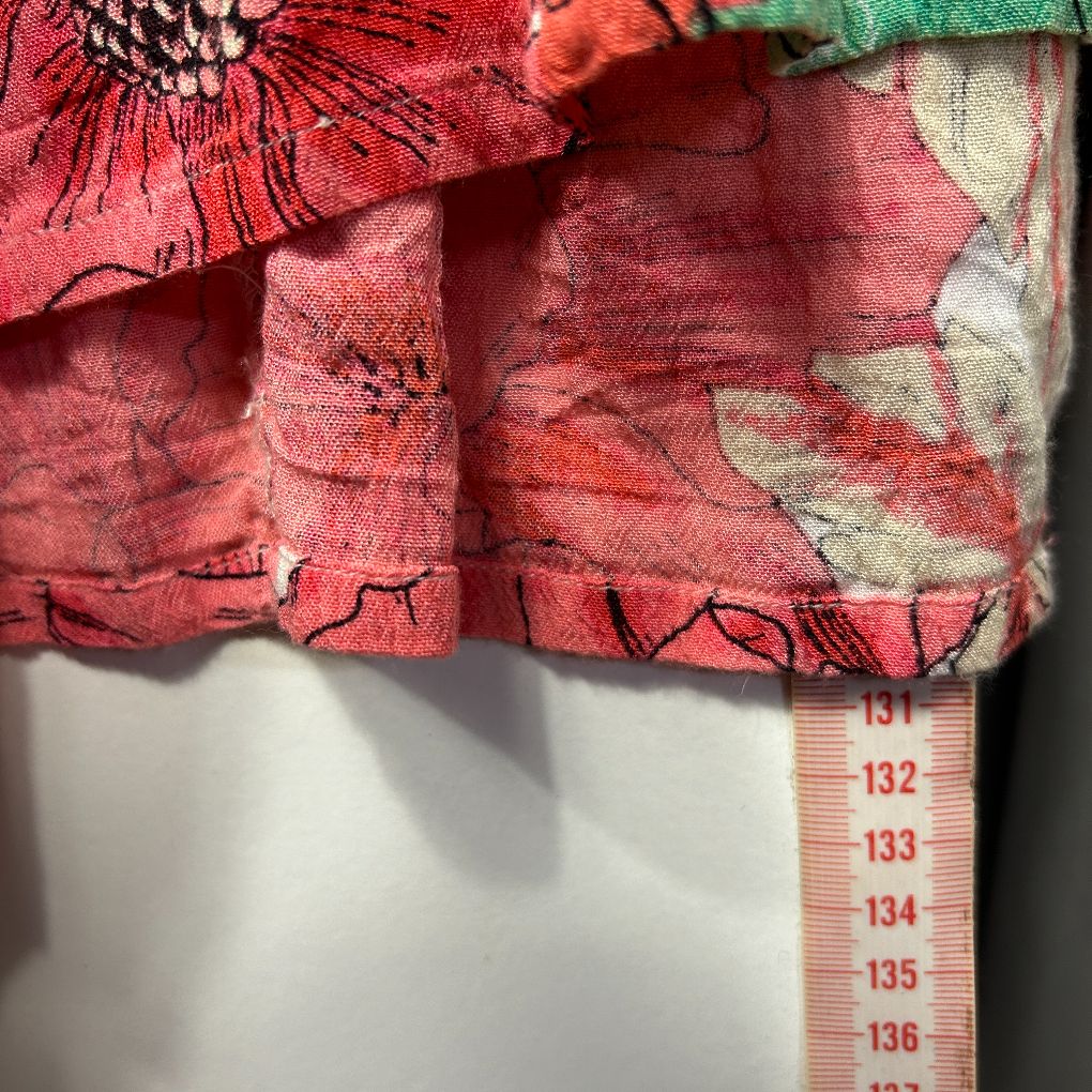 Red floral fabric detail view with measurement scale