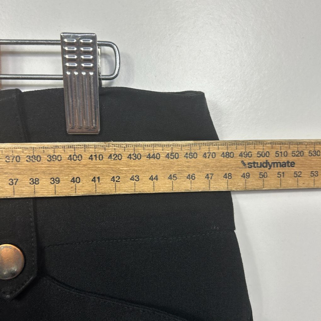 Black shorts waistband detail with measuring tape