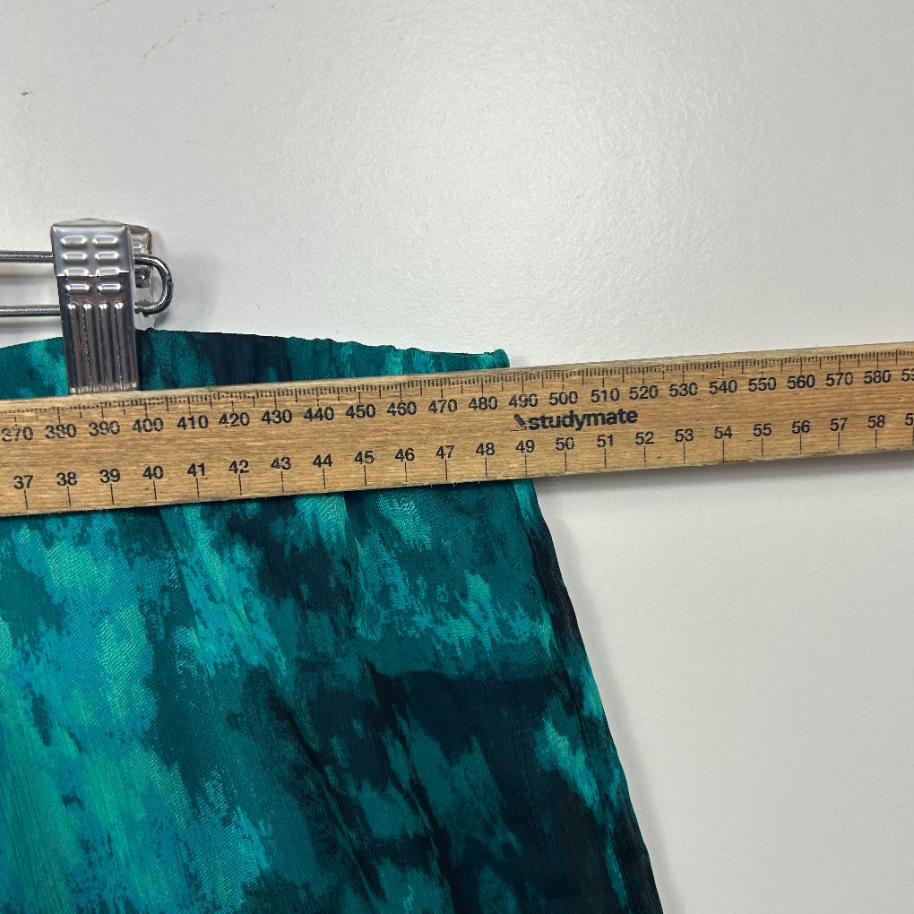 Teal fabric detail with measuring tape