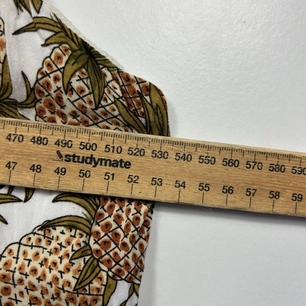 Pineapple print fabric detail view with measuring ruler
