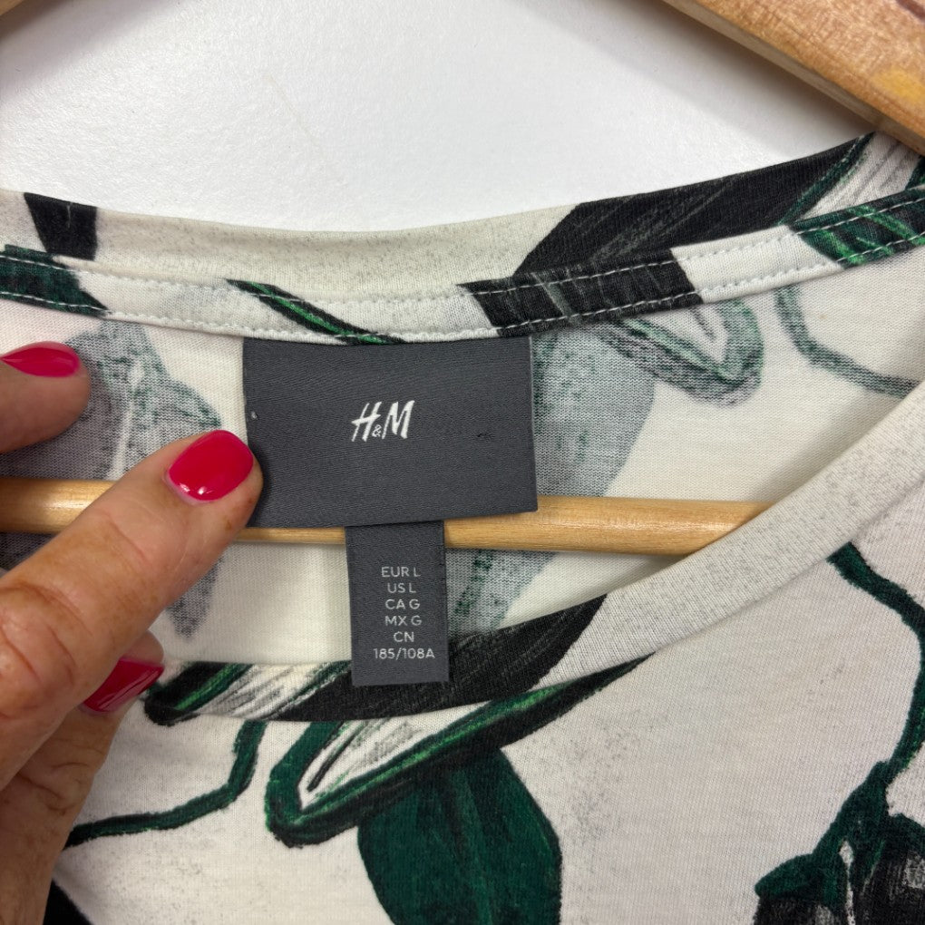 White top with black and green floral pattern label view