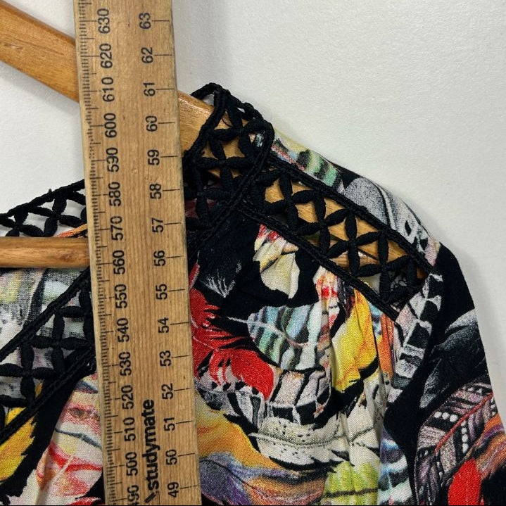Black graphic print top detail view with measuring tape