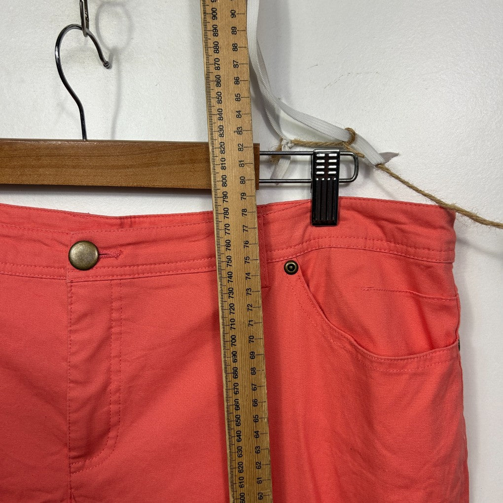 Red pants front view on hanger with measuring tape
