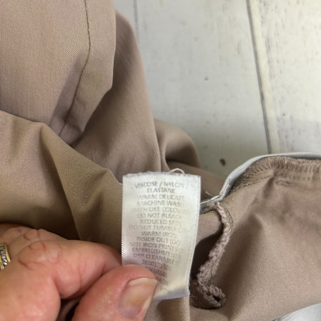 Beige garment label detail view