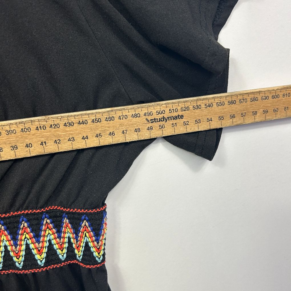 Black pants with geometric patterned hem detail view