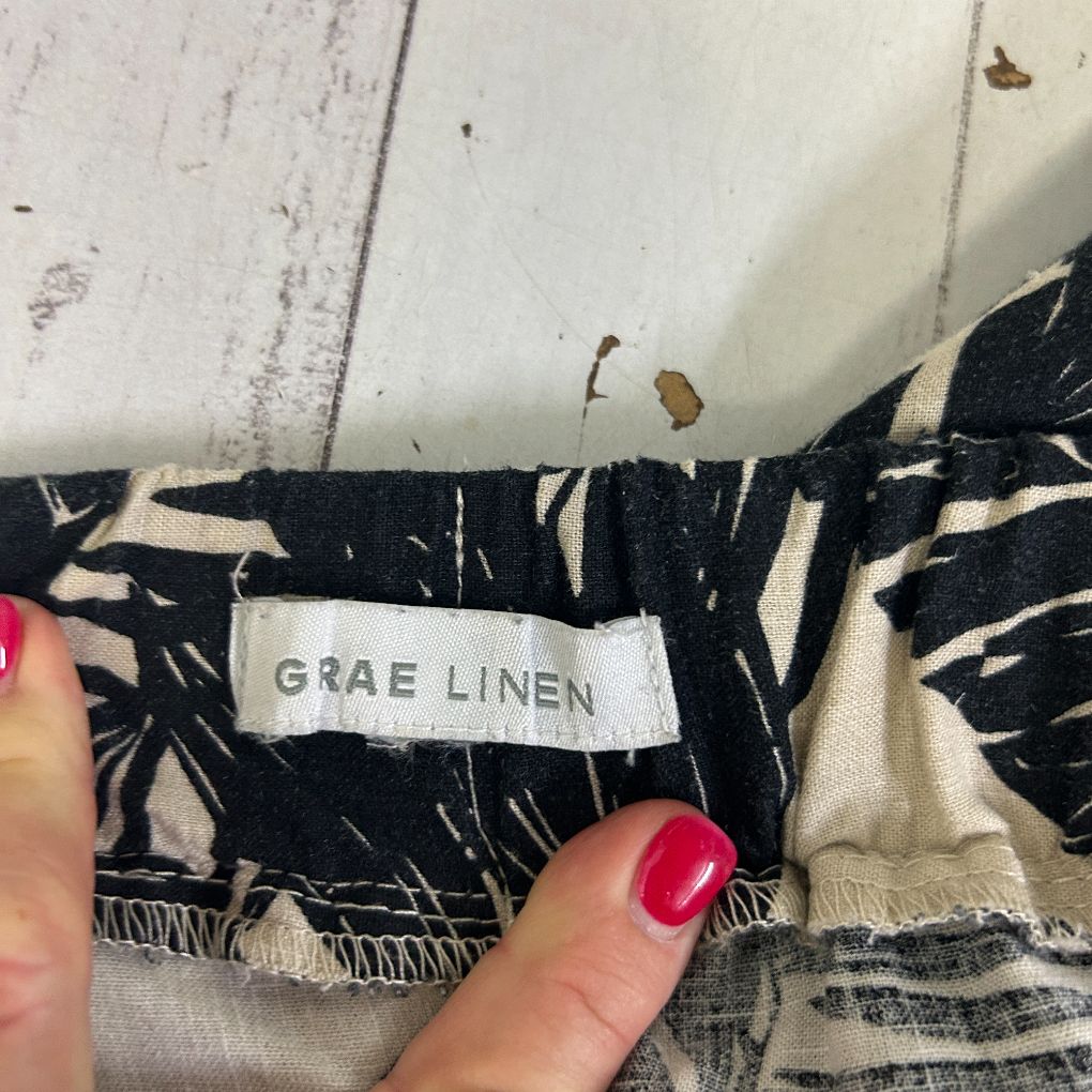 Black and white striped linen garment label detail view