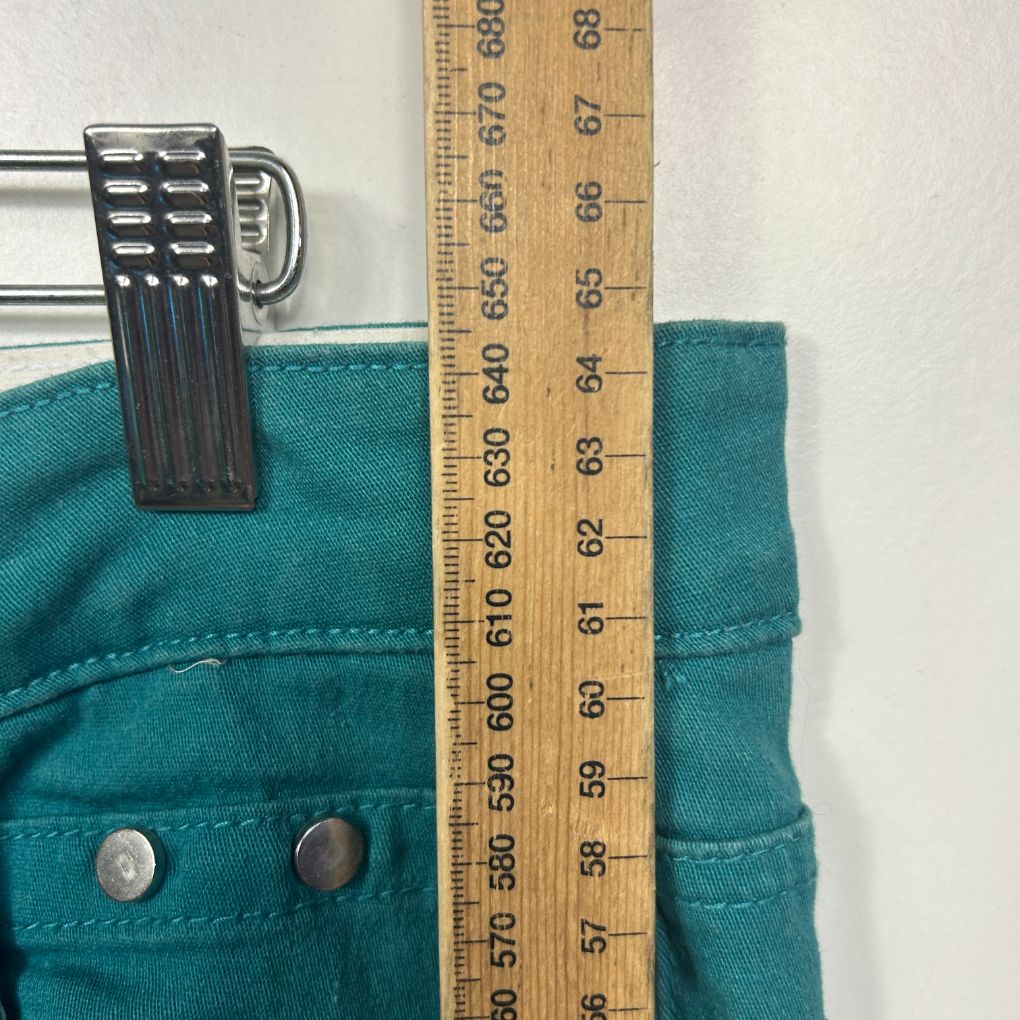 Teal pants front view with measuring tape
